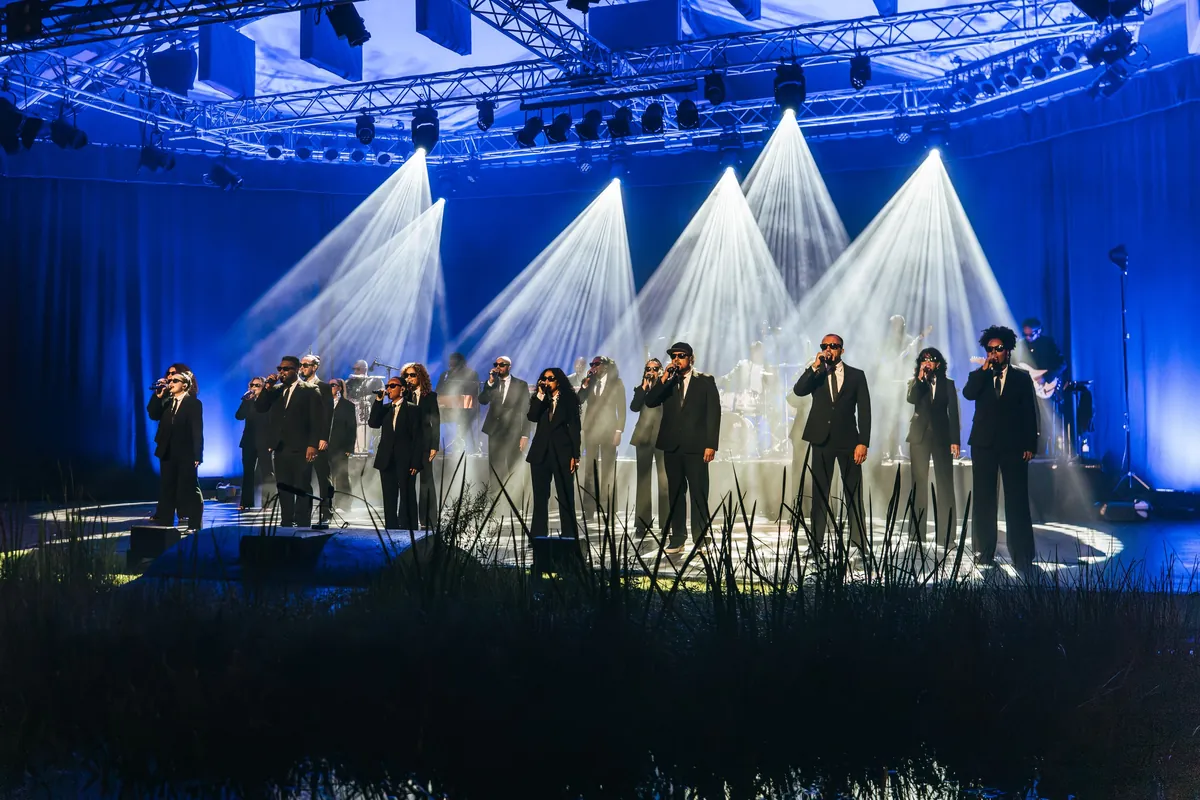 ZO! Gospel Choir on an open-air stage under white beams
